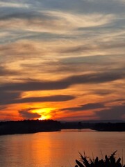 Beautiful golden sky by the sunset over the river in Laos