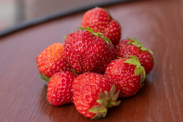 bunch of ripe strawberries lying on the table, a summer berry, a strawberry harvest, a beautiful summer picture