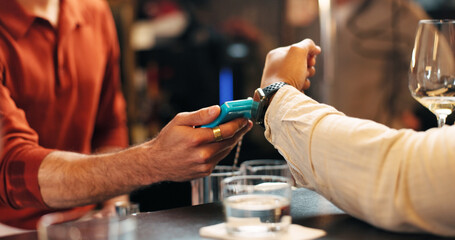 Person, hands and POS machine with watch for payment, wireless transaction or easy banking in bar....