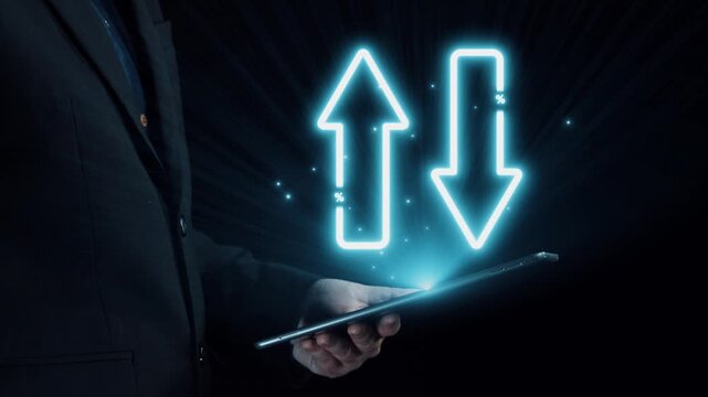 A businessman holds a tablet, showcasing neon arrows representing rising quality and falling cost against a dark backdrop, illustrating financial dynamics and market trends. Qubit