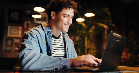 Night, remote work and man with laptop, coffee shop and email marketing on web, research and...
