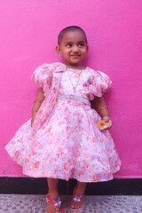 Adorable Young Girl With a Sweet Smile Wearing a Beautiful Floral Dress