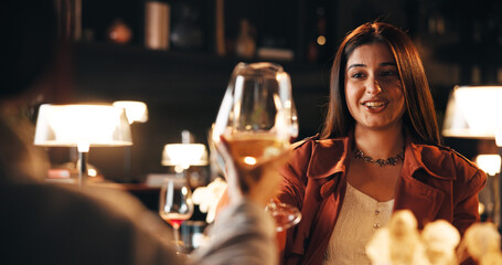 Woman, happy and toast on date at restaurant with wine glass, cheers and bonding for relationship...