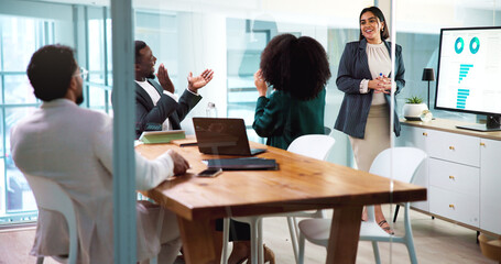 Woman, presentation and team with applause for finance results, charts and smile by monitor at...