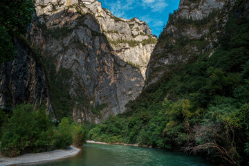 Emerald river winding through steep cliffs in Balagezong Canyon, Shangri-La, China