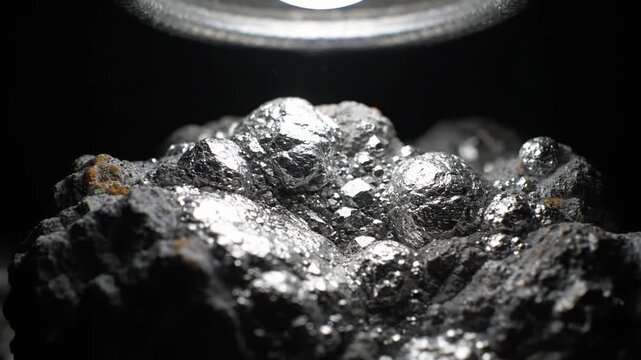 Closeup of raw silver ore mineral, slow zoom in