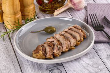 Roasted duck breast slices in the plate