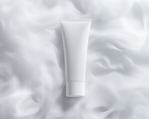 Cream tube lies on white organza fabric. Monochrome horizontal mockup of cosmetics with soft texture. Flat lay of matte plastic packaging, studio light