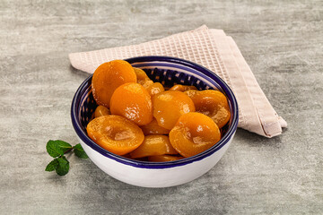 Sweet canned apricots with syrope