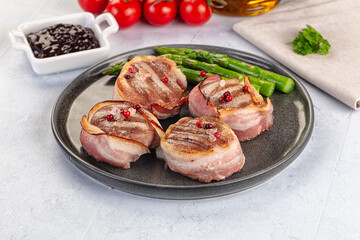 Tasty grilled pork medallion with bacon