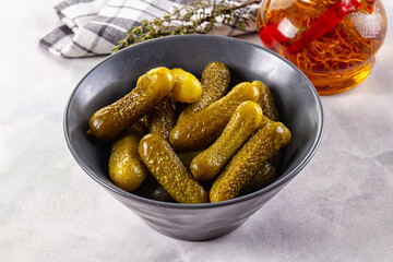 Marinated canned green cornichon cucumbers