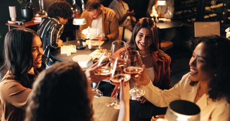 Happy women, friends and night with cheers in restaurant for celebration, toast or get together....