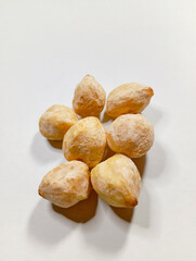 Candlenuts on Wooden Cutting Board with Dark Grey Background