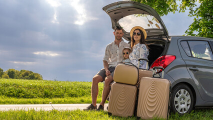 Family in car. Man woman child traveling. Summer adventure road smile.