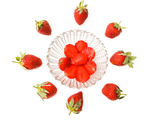 Fresh red strawberries isolated on a white background. And half berries served on transparent plate.