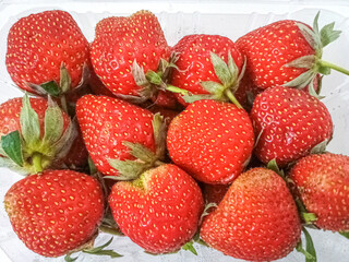 Fresh red strawberries isolated on a white background.
