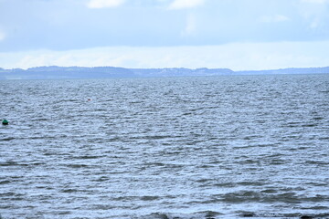 blue sea water with mountain background