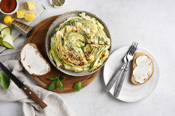 Vegetable pie with the ingredients and bread on white background, top view