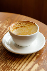 Empty cup of hot milk latte coffee on table by the window.