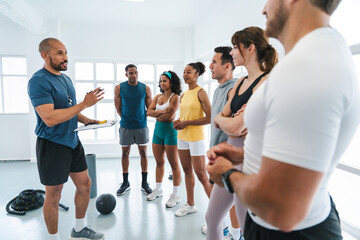 Multiethnic group of sportive people doing functional workout at the gym, concepts about sport and...