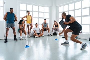 Multiethnic group of sportive people doing functional workout at the gym, concepts about sport and...