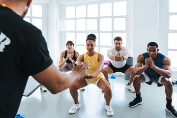 Multiethnic group of sportive people doing functional workout at the gym, concepts about sport and...