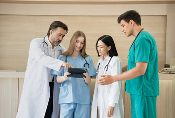 Caucasian woman doctor use tablet computer with team working at hospital	