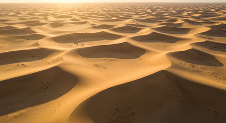 Endless expanse of golden sand dunes under a hazy sunlit sky
