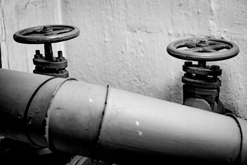 Old Industrial Pipes and Valves in a Dark Room - monochrome