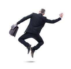 A businessman in a dark suit, holding a briefcase, jumps joyfully as he celebrates his success.
