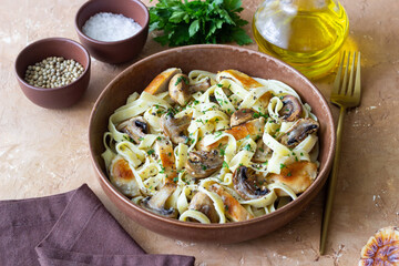 Fettuccine pasta with chicken and mushrooms in creamy sauce. Italian cuisine. Recipe.
