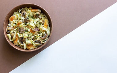 Fettuccine pasta with chicken and mushrooms in creamy sauce. Italian cuisine. Recipe.