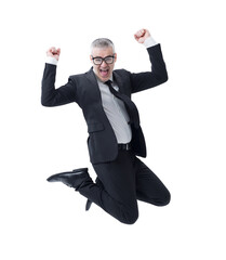 A businessman in a dark suit, jumps joyfully as he celebrates his success.