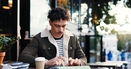 Remote work, tablet and man at outdoor cafe as social media marketer with research. Technology,...