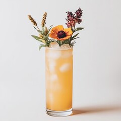 A tall, amber cocktail garnished with wildflowers