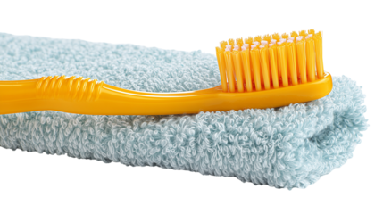 Yellow toothbrush on a blue towel