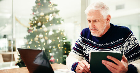 Christmas, tablet and businessman with laptop in office for finance, budget or investment proposal....