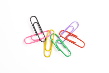 Many colorful paper clips isolated on white background, top view