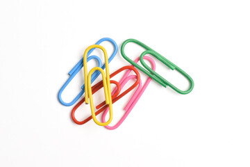 Many colorful paper clips isolated on white background, top view