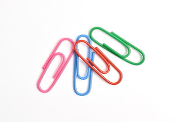 Many colorful paper clips isolated on white background, top view
