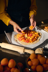 Woman Preparing Apricot Tart with Rustic Dough in Warm Kitchen Setting