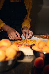 Woman Preparing Pastry with Fresh Apricots in a Culinary Setup