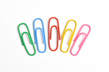 Collection of colorful paper clips isolated on white background, top view