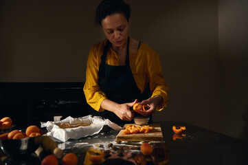 Woman Preparing Fresh Apricot Tart in a Cozy Kitchen Setting