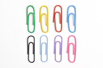 Collection of colorful paper clips isolated on white background, top view