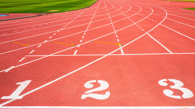 A running track with the numbers one, two, three and running lines on the field.