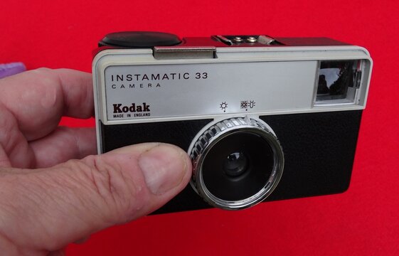 Kodak Instamatic 33 vintage camera showing light settings on red background