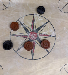 Top view of a carrom board with few coins