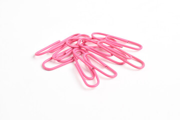 Many pink paper clips isolated on white background