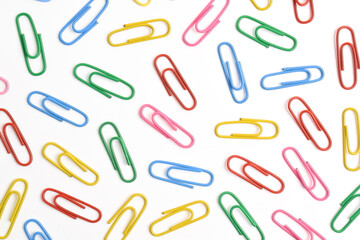 Colorful paper clips isolated on white background, flat lay, top view